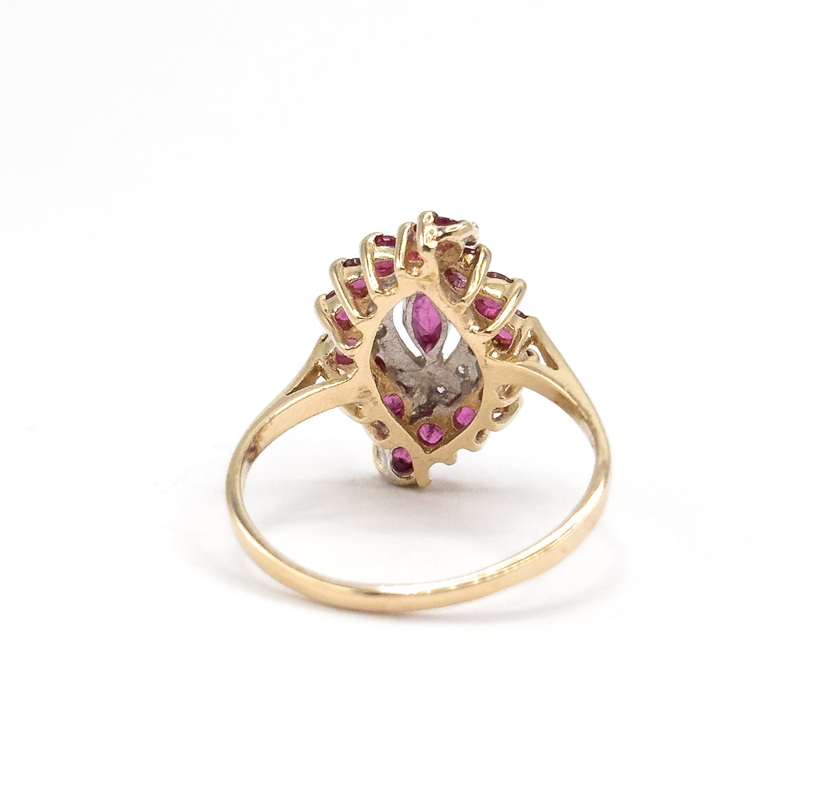 Almost the same view with slightly different angle, closer from behind so the open backs of the settings show the rubies from underneath and the split shoulders meeting the head.