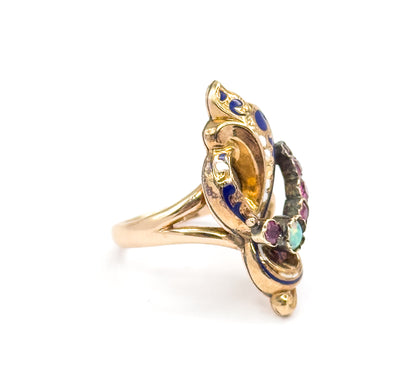 Angled side view showing the scrolling enamelled face in profile, with the opal cabochon and a line of small rubies curving along the outer edge toward the shoulders.