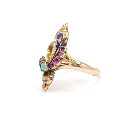 Three-quarter front view where the opal cabochon shows blue and green flashes beside the curving row of rubies, with the shank sweeping back and down behind the face.