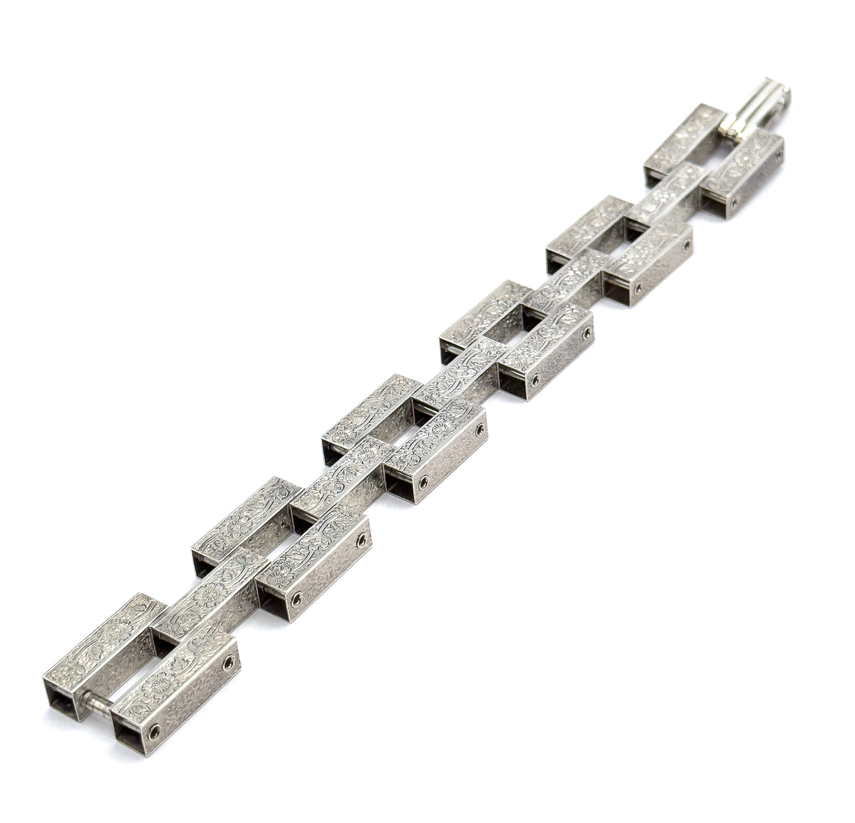 Angled end-on view down the length of the bracelet, showing the hollow square openings of each bar, the hinge pins between links, and the clasp at the far end.