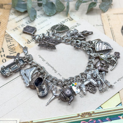 Silver charm bracelet on a vintage newspaper background