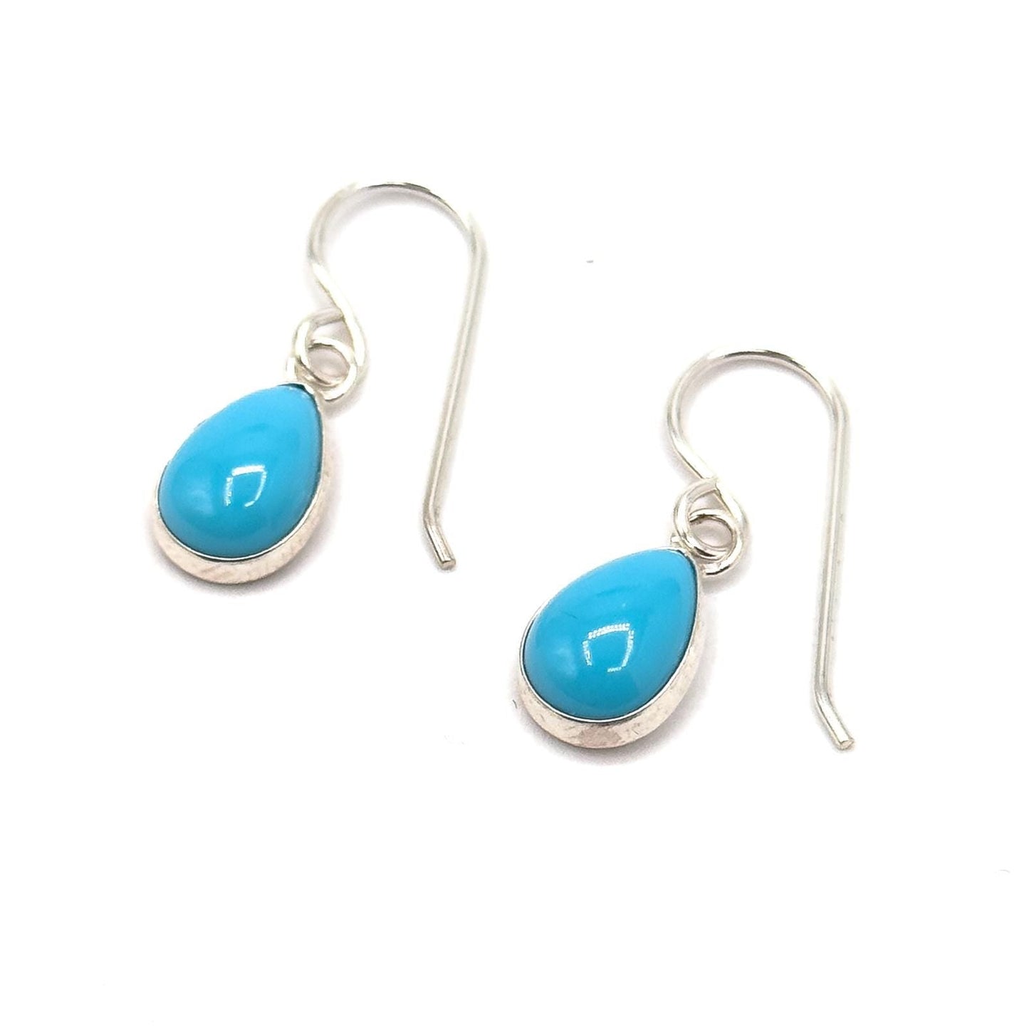 Turquoise teardrop earrings with silver hooks on a white background