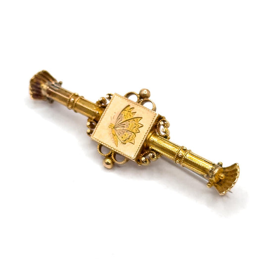 Gold decorative item with a central square design on a white background