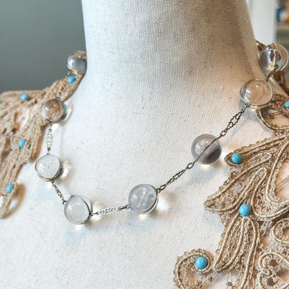Necklace with beads and turquoise stones on a mannequin with lace garment
