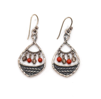 Both earrings straight on against white, full length from the curved ear wire hooks down to the pointed teardrop tips, with four small beads — two red, two clear — alternating on the rope-twist bar of each.